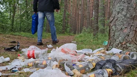 Man and garbage dump in the forest. Environmental pollution. Stock Footage 156712136