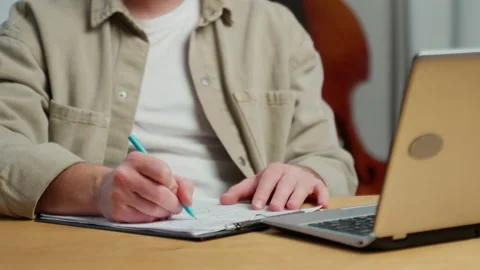 A man and hands writing in a notebook, diary and strategic ideas. A close-up of Stock Footage 239670749