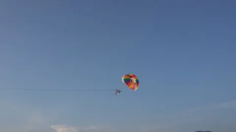 Man and instructor flying on a parachute. Active rest on the beach in summer. 스톡 동영상 106747104