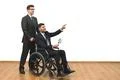 The man and the invalid hold papers on the white wall background Photo