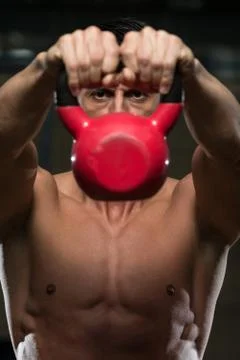 Man and kettle bell Stock Photos