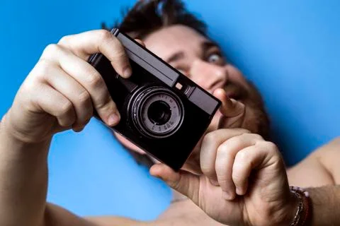 Man and old camera Stock Photos