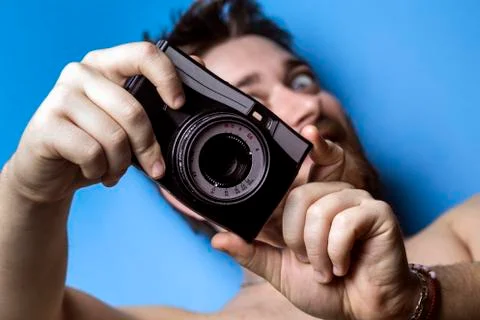 Man and old camera Stock Photos