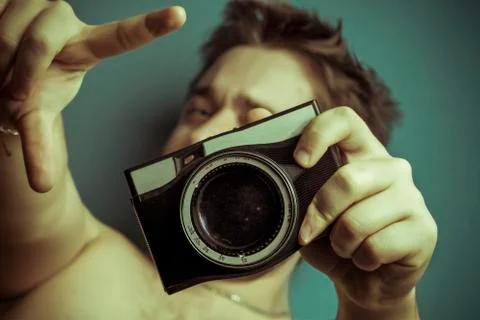 Man and old camera Stock Photos