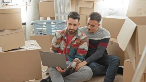 Man and partner sit on floor holding laptop while partner rests hand on his.. Stock Footage 339218222