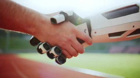 Man and robot shaking hands at stadium. Blurred background. Sport concept. Robot Stock Footage 231239617
