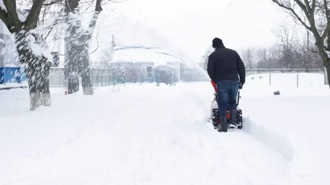 A man and a snowplow. Stock Footage 233560384