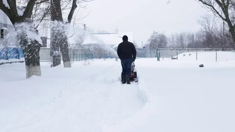 A man and a snowplow. Stock Footage 233560391
