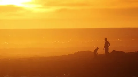 Man and Son Playing by Ocean at Sunset Stock-Footage 46768035