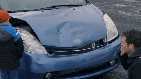 Man and son stand in front of wrecked car as dads on the phone Stock Footage 104702695
