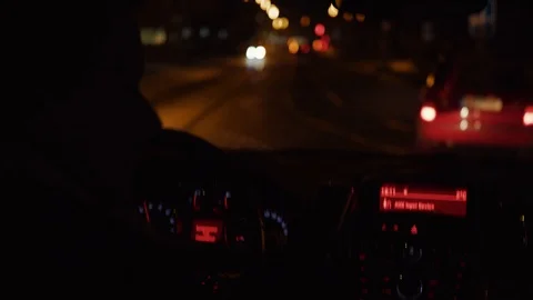Man and steering wheel during car driving on dark night road Stock Footage 102906774