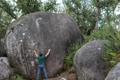 Man and stone Stock Photos
