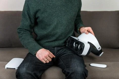 Man and virtual reality headset with remote control Stock Photos