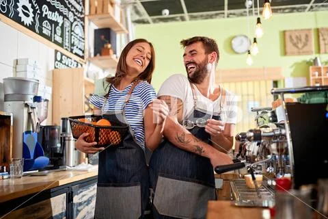 Man and woman barista owner working at coffee shop. Stock Photos