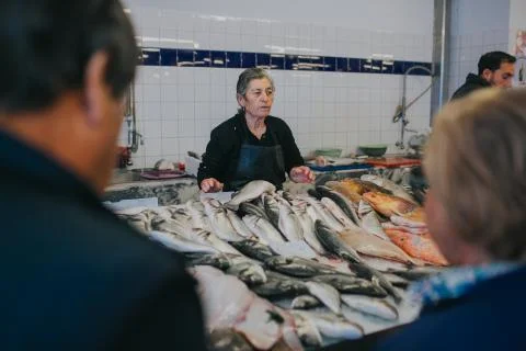 A man and a woman buy fresh seafood at a fish market Stock Photos