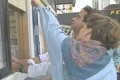 A man and a woman buy tickets for the South Street Seaport museum Footage