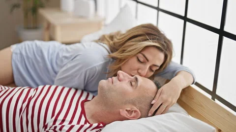 Man and woman couple lying on bed kissin... | Stock Video | Pond5