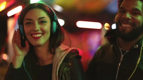 Man and woman dancing to the rhythm of music with headphones Stock Footage 59556069