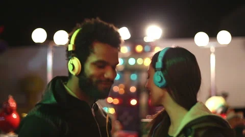 Man and woman dancing to the rhythm of music with headphones Stock Footage 59556135
