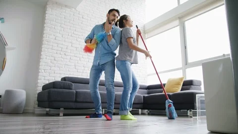 Man And Woman Dancing While Cleaning Home Video stock 92768420