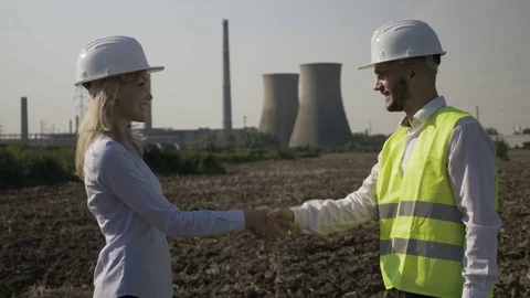 Man and woman developers shaking hands after a successful engineering project Stock Footage 82177977