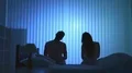 The man and woman doing exercise near the bed. night time 4k or 4k+ Resolution