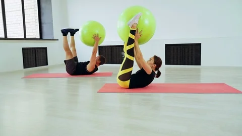 Man and woman doing exercise on the abdominal muscles using fitball. Stock Footage 112010190