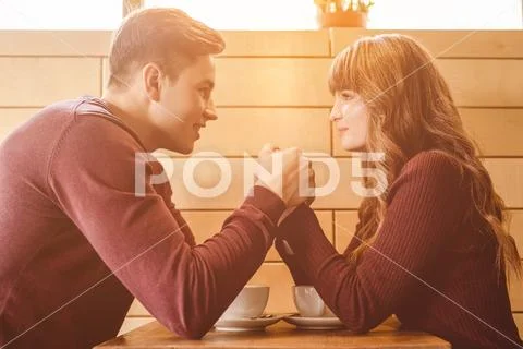 The man and woman drink a coffee in the restaurant Stock Photos
