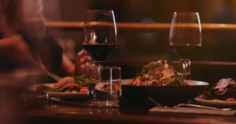 Man and woman eating gourmet dinner at fine dining restaurant Stock Footage