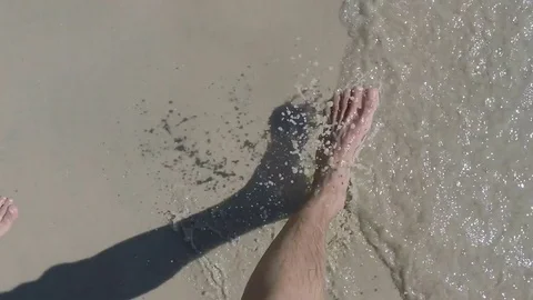 Man And Woman Feet Point Of View Walking On Sandy Beach With Water Waves Stock Footage