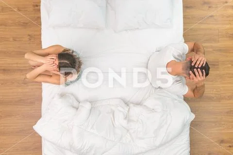 The man and woman hold head on the bed. view from above Stock Photos