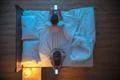 The man and woman hold a phone on the bed. evening night time. view from abov Photo