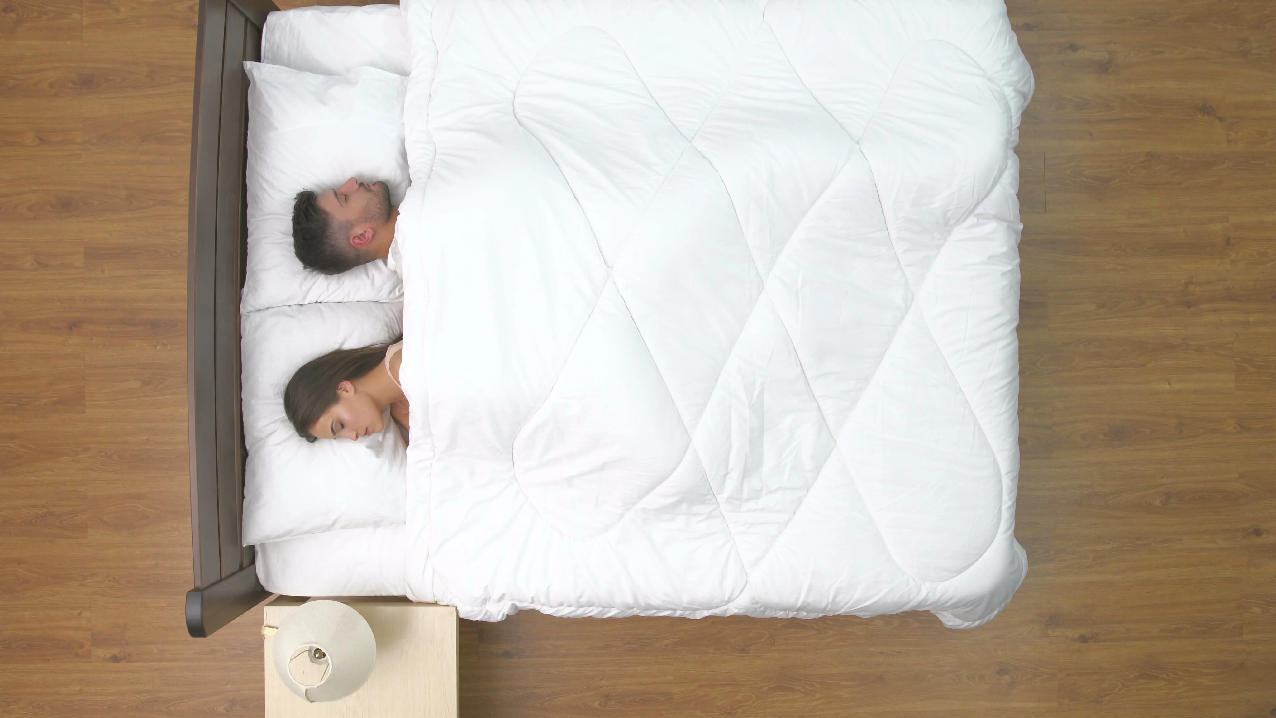 The man and woman kiss in the bed. view from above