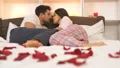 The man and a woman kissing on the bed with rose petals 4k or 4k+ Resolution