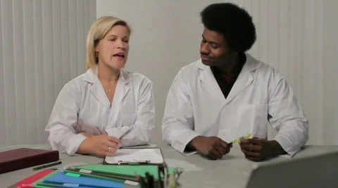 Man and woman in lab coats Stock Footage