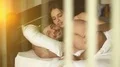The man and woman lay on the bed over the glass 4k or 4k+ Resolution