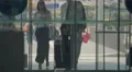 Man and woman in long dress enter airport hall through automatic opening doors 4k or 4k+ Resolution