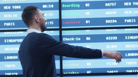 Man and Woman meeting in the Airport Arrival Hall next to Information Board. Stock Footage