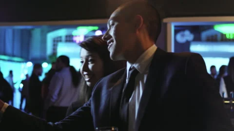 Man and woman at a nightclub take a selfie together with a cell phone Stock Footage