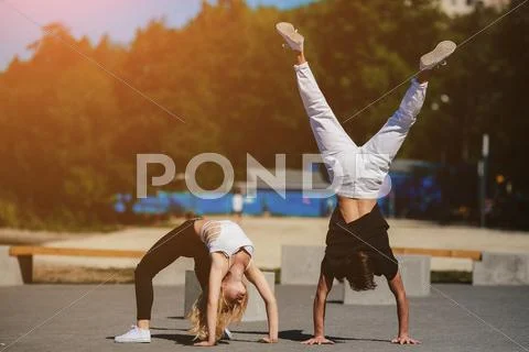 Man and woman performing tricks Stock Photos