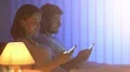 The man and woman phone on the bed. night time 4k or 4k+ Resolution