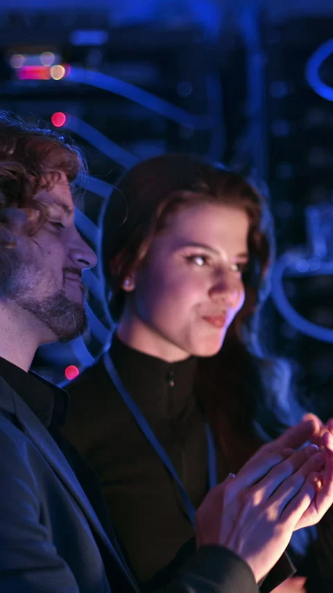 A man and a woman programming in a server room. Vertical Stock Footage 287380258
