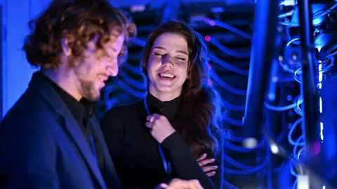 A man and a woman programming in a server room Stock Footage 287430142