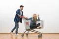 The man and a woman ride on the cart on a white wall background Photo
