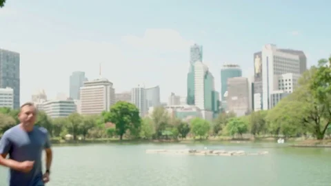 Man and woman runners jogging in park. Fit female male sport fitness running Stock Footage
