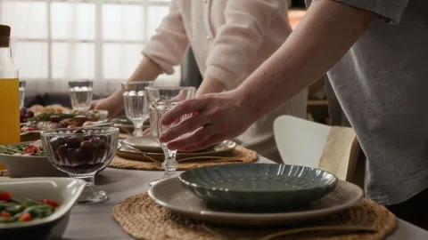 Man and Woman Setting Table with Glasses for Dinner Party Stock Footage 340330175