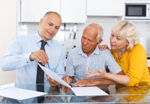 Man and woman signing agreement papers with social worker Stock Photos