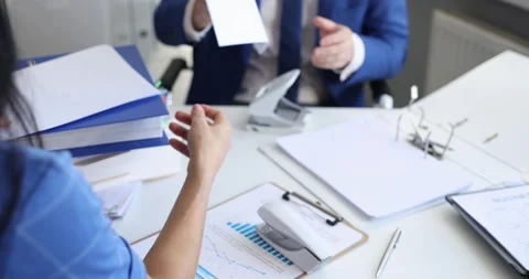 Man and woman sorting documents with stapler and hole punch and folding into Video stock 257060891