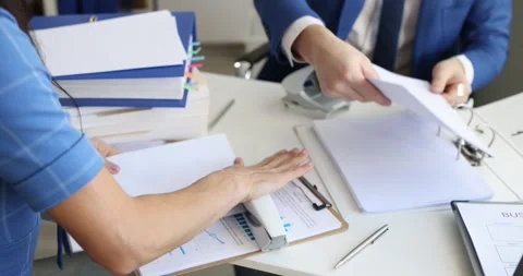 Man and woman sorting documents and putting them in folders in office 4k movie Video stock 262316241