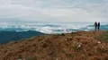 The man and woman standing on the mountain with a beautiful landscape 4k or 4k+ Resolution